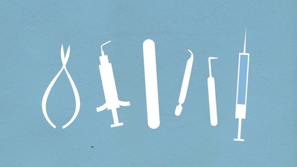 assorted cutout paper medical tools on blue background